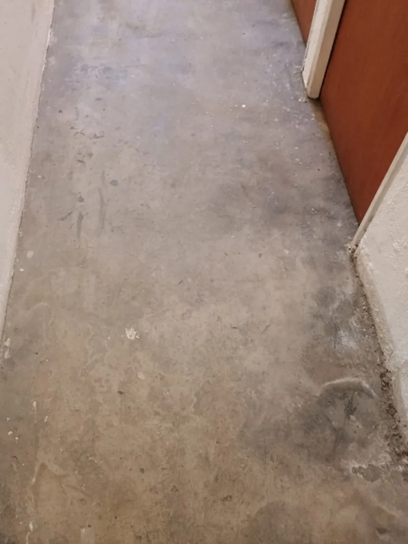 Antes — Corredor con el piso de cemento manchado y desgastado